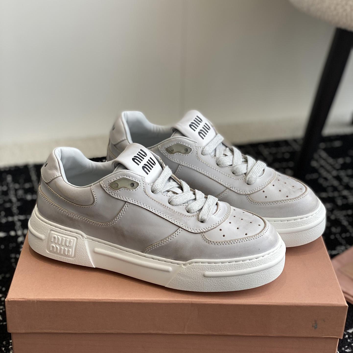 Miu Miu Bleached Leather Sneakers - FashionPlug