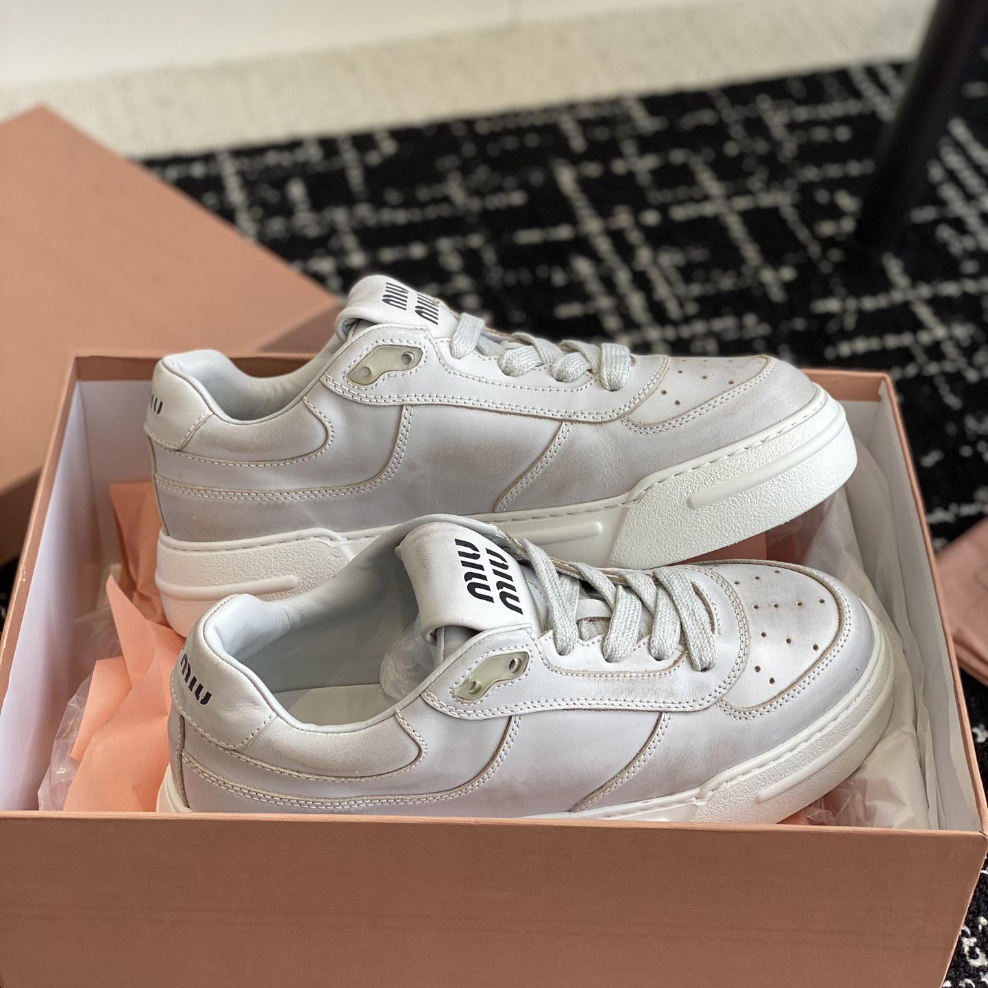 Miu Miu Bleached Leather Sneakers - FashionPlug