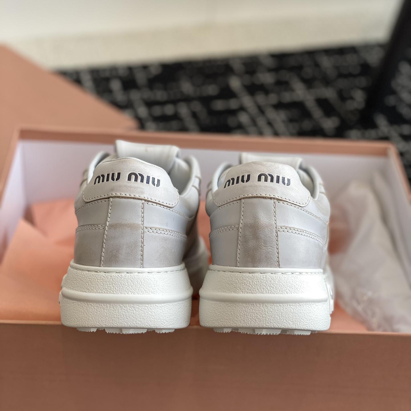 Miu Miu Bleached Leather Sneakers - FashionPlug