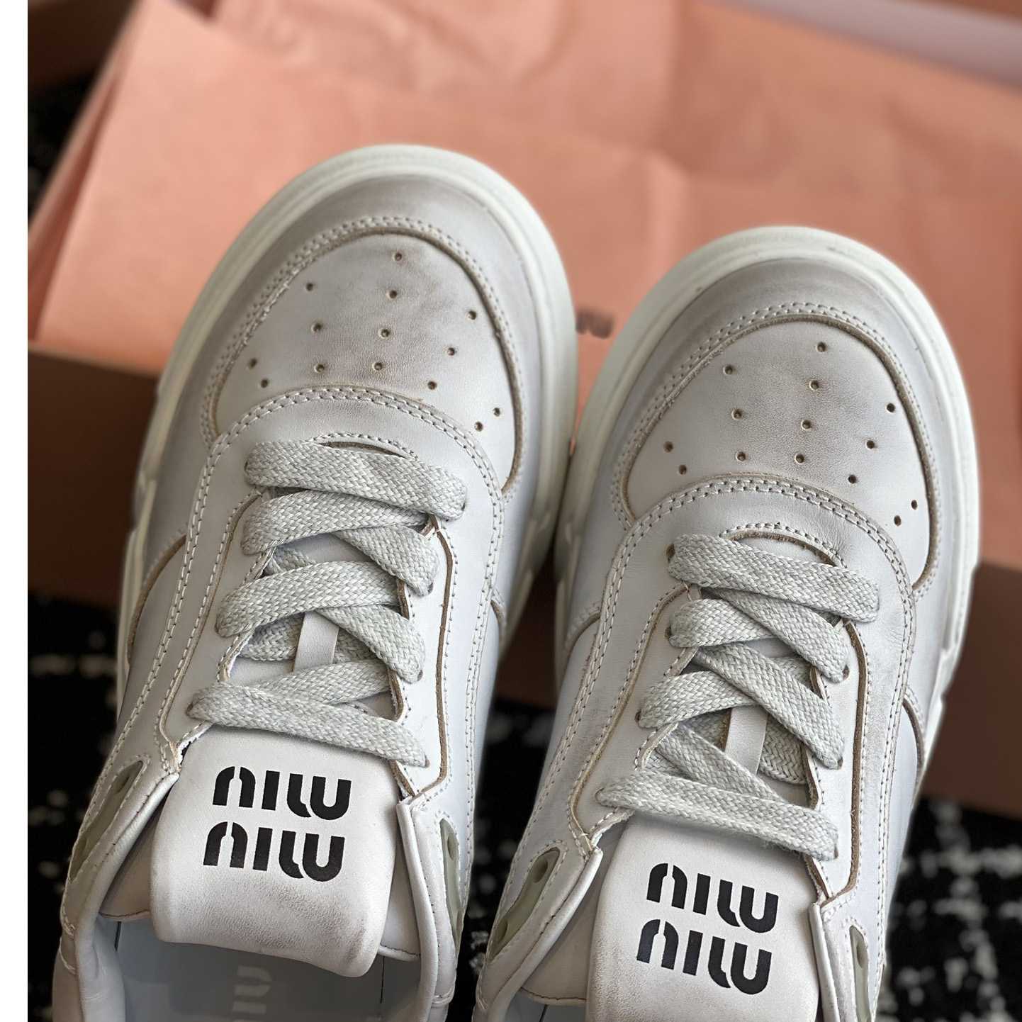 Miu Miu Bleached Leather Sneakers - FashionPlug