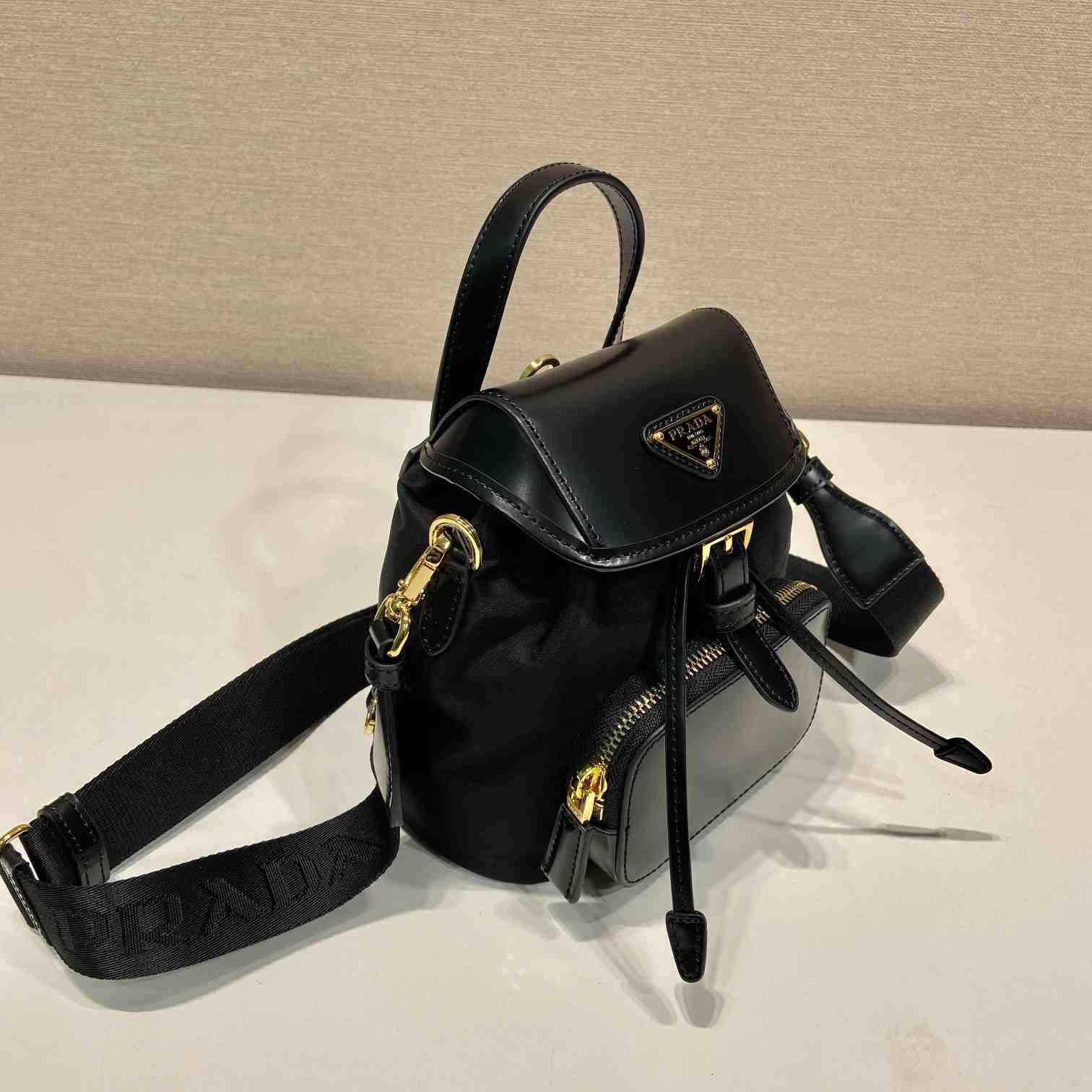 Prada Small Re-Nylon And Brushed Leather Backpack - FashionPlug