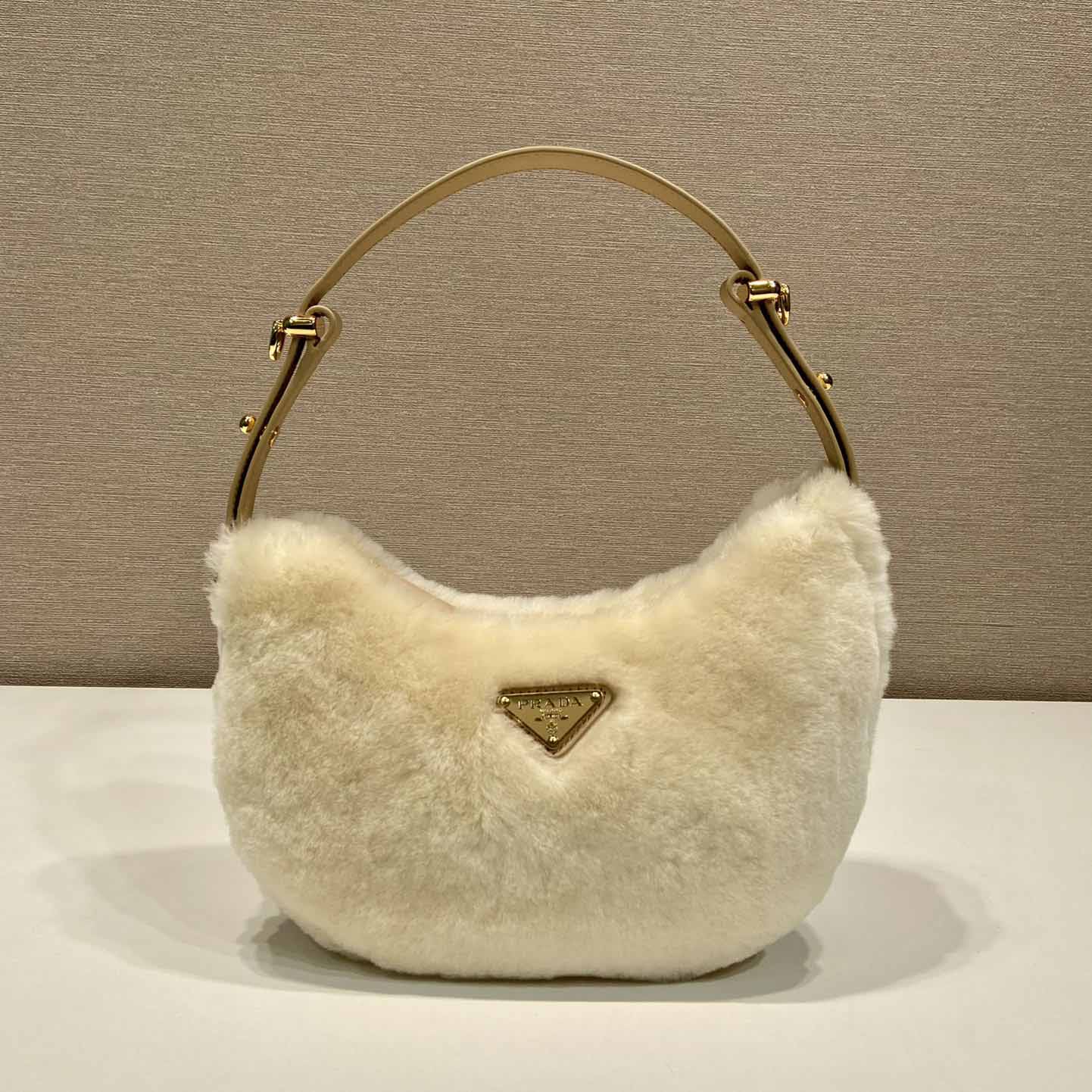 Prada Arqué Shearling And Leather Shoulder Bag - FashionPlug