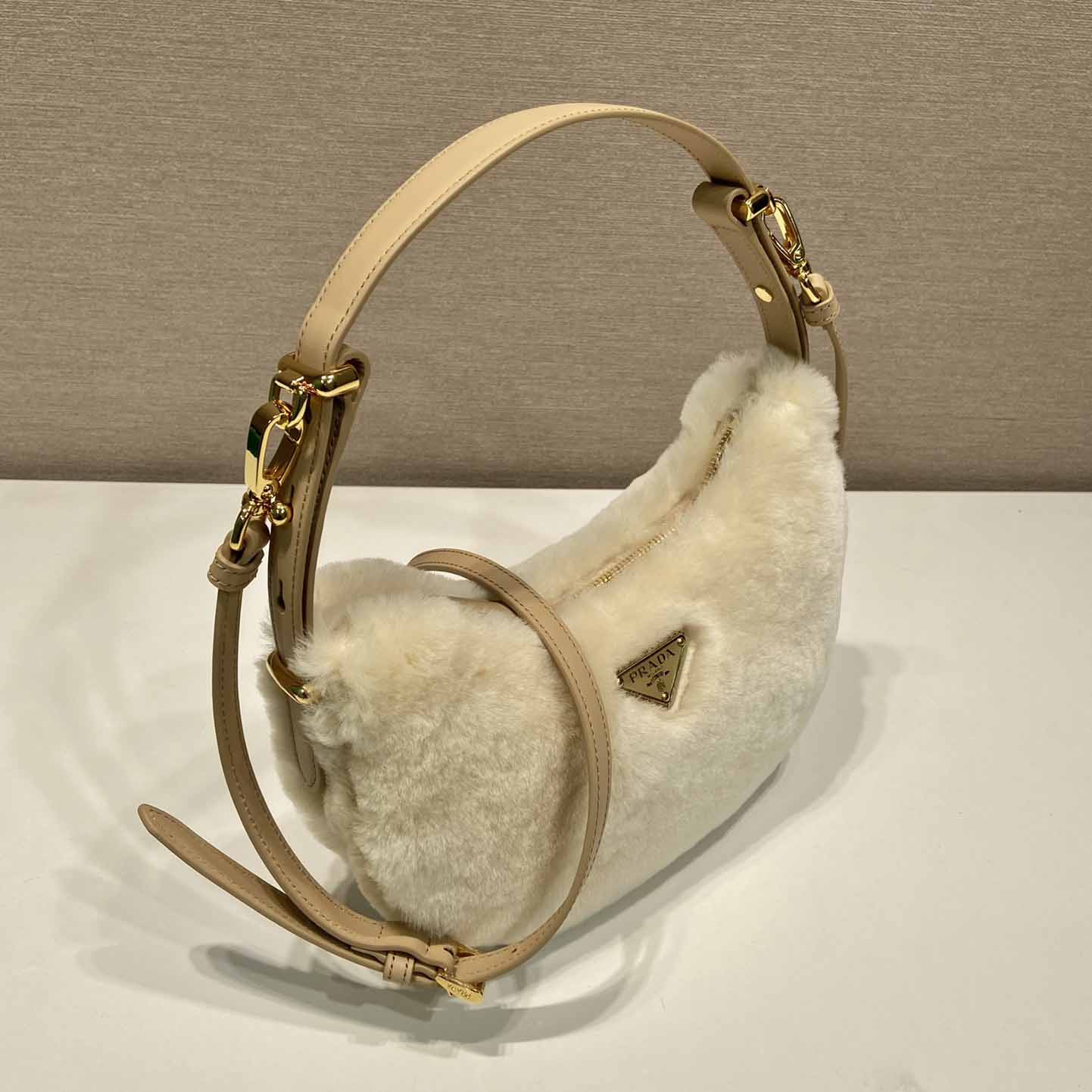 Prada Arqué Shearling And Leather Shoulder Bag - FashionPlug