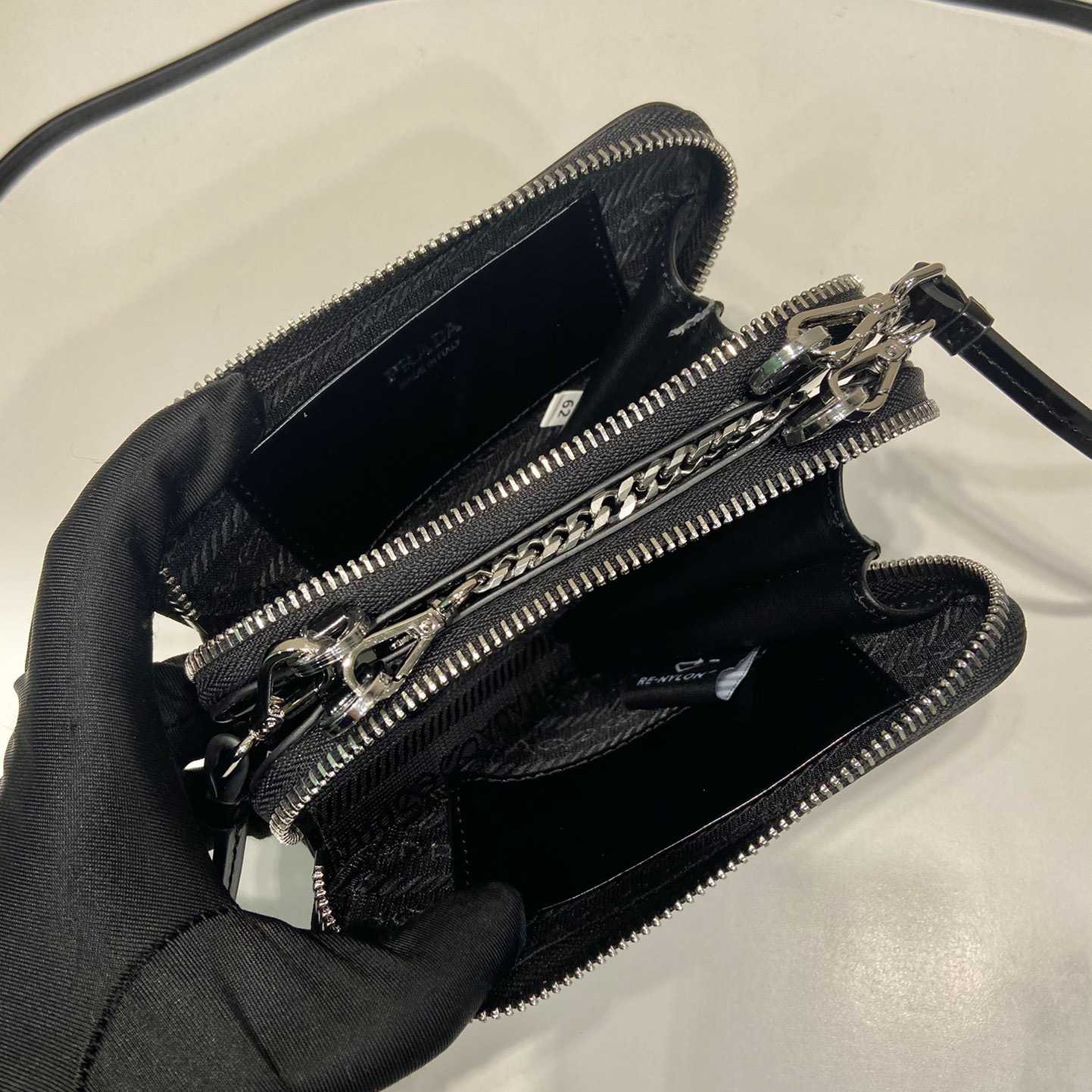 Prada Triangular Embellished Satin And Leather Mini-pouch - FashionPlug