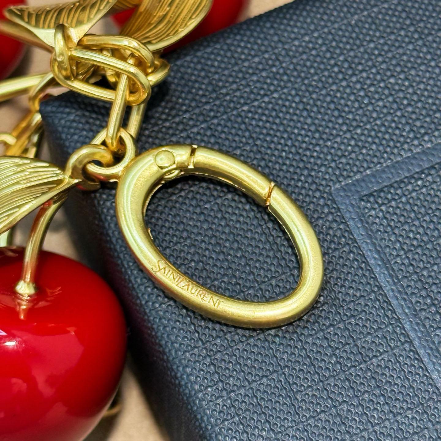 Saint Laurent CASSANDRE Cherry Bag Charm In Resin And Metal - FashionPlug