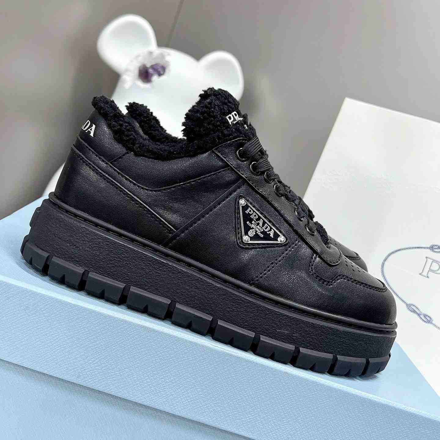 Prada Leather And Shearling Sneakers - FashionPlug