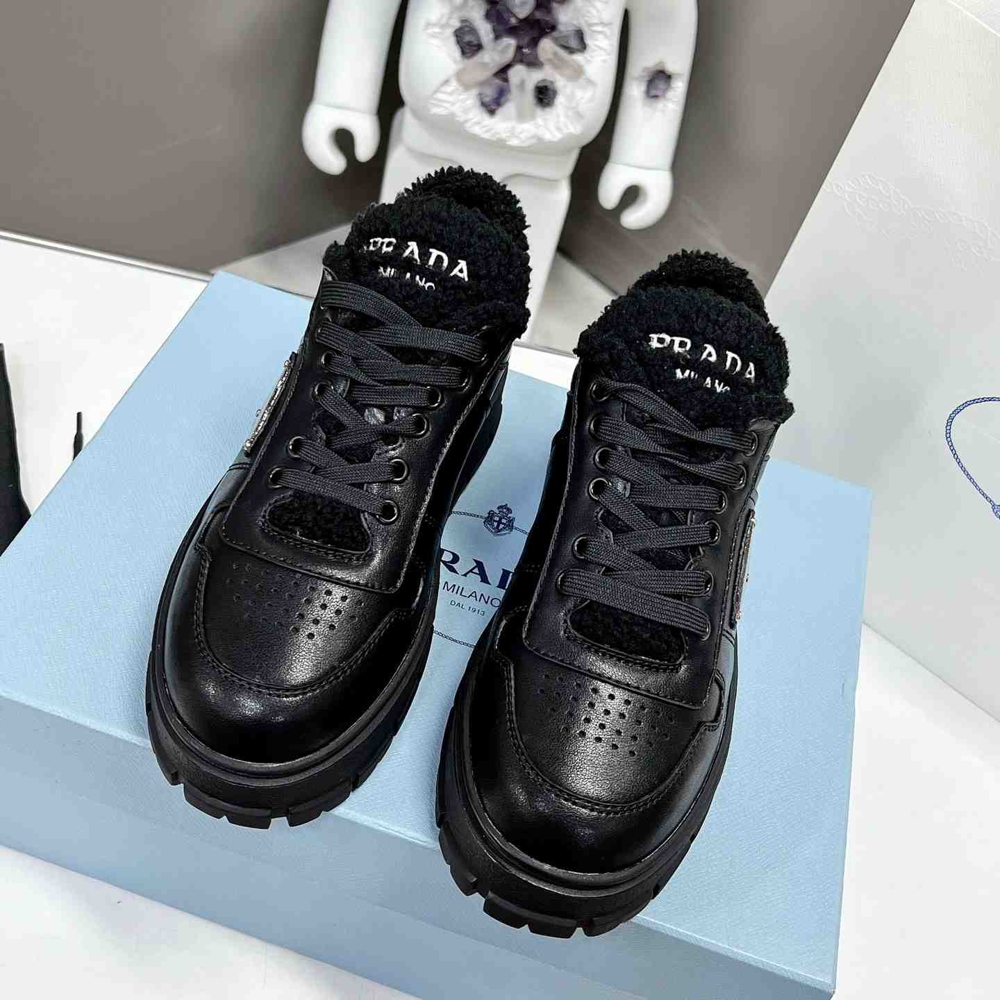 Prada Leather And Shearling Sneakers - FashionPlug