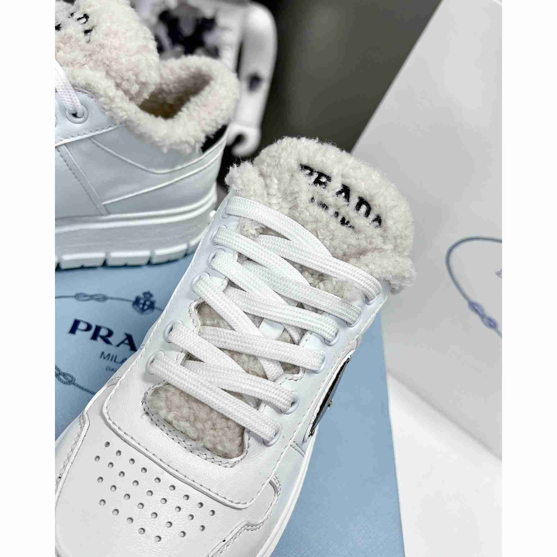 Prada Leather And Shearling Sneakers - FashionPlug