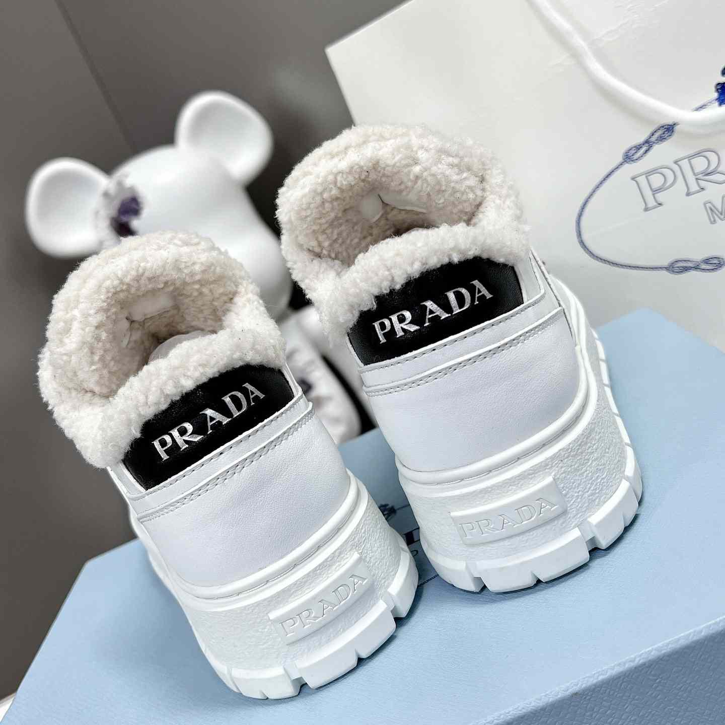Prada Leather And Shearling Sneakers - FashionPlug