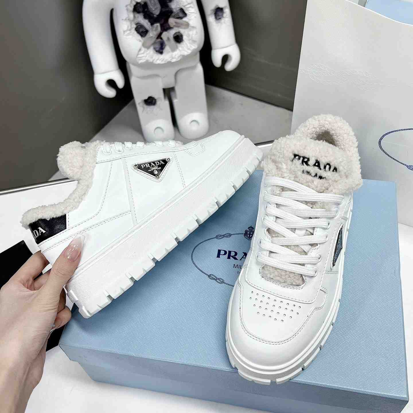 Prada Leather And Shearling Sneakers - FashionPlug