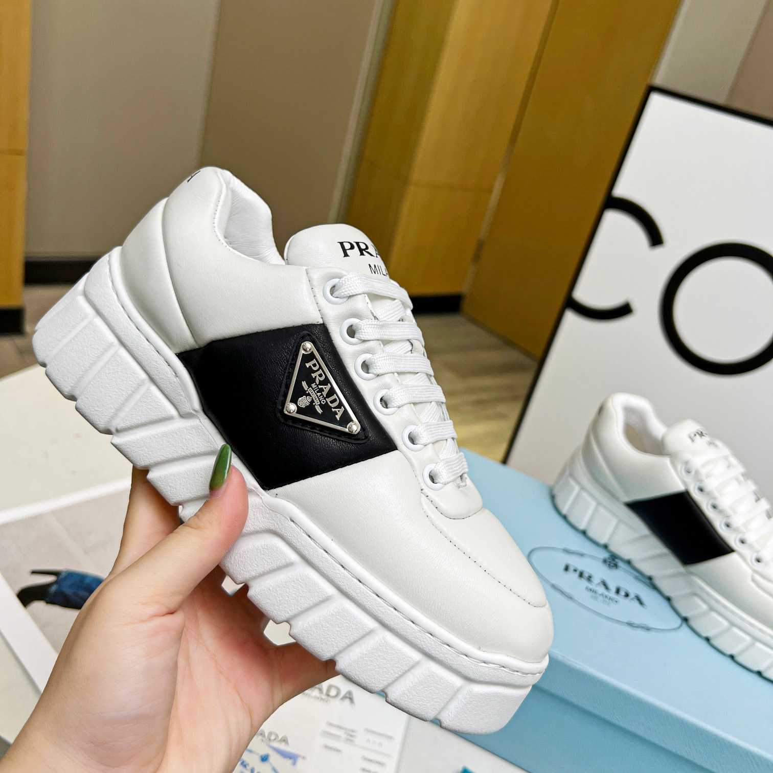 Prada Padded Nappa Leather Sneakers - FashionPlug
