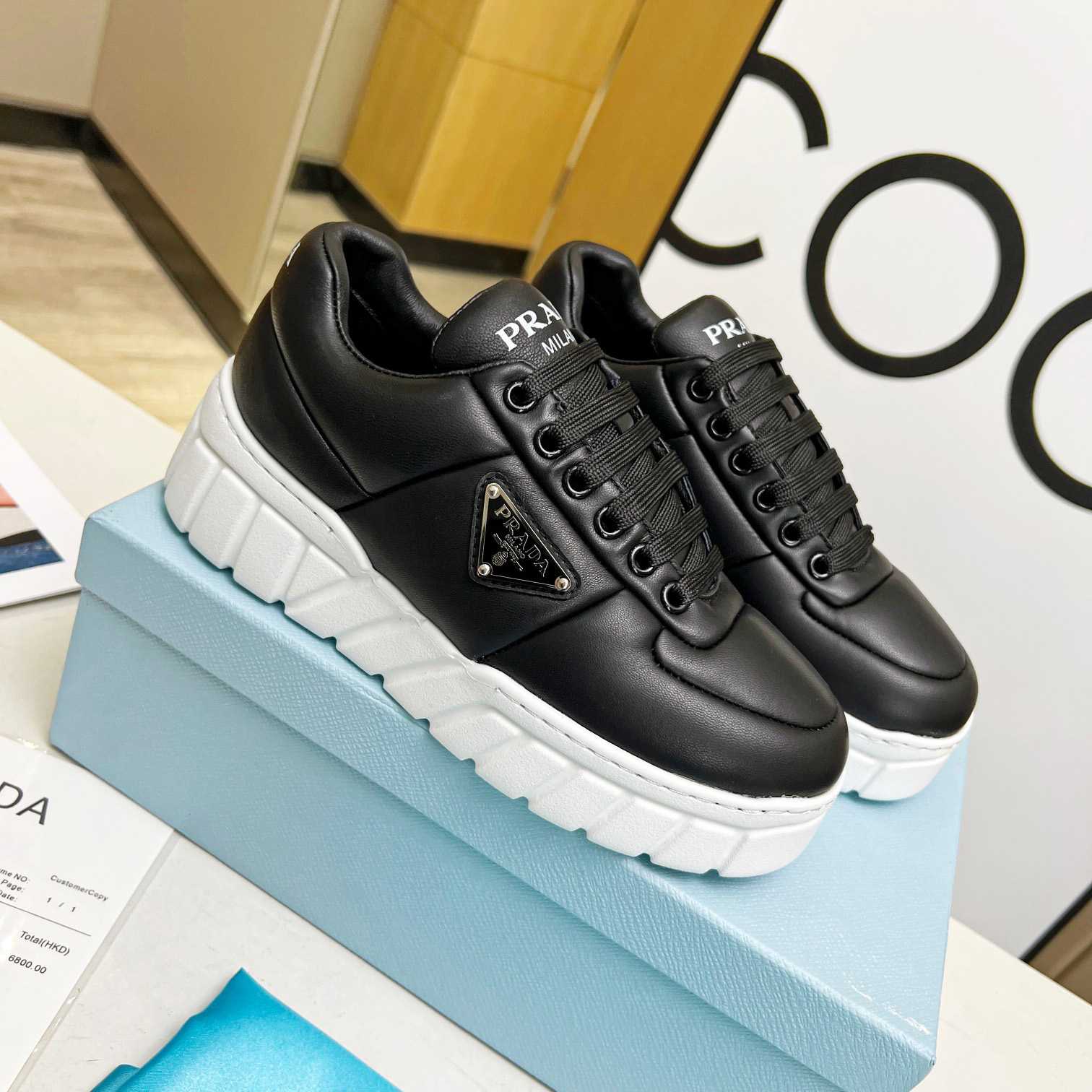 Prada Padded Nappa Leather Sneakers - FashionPlug