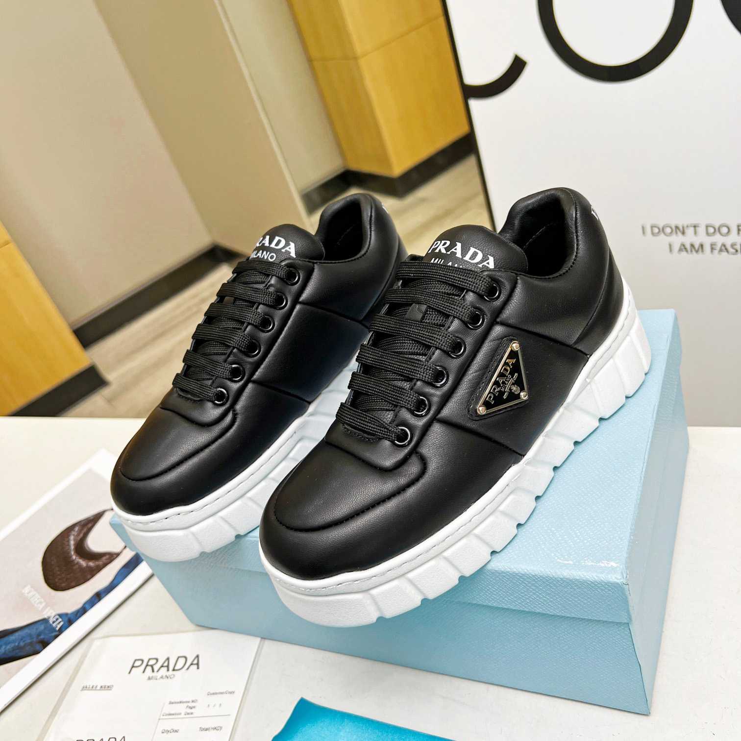 Prada Padded Nappa Leather Sneakers - FashionPlug