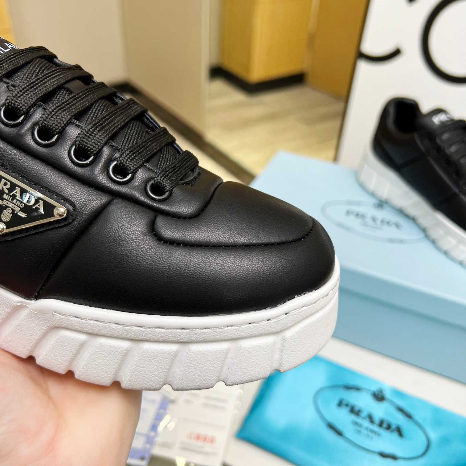 Prada Padded Nappa Leather Sneakers - FashionPlug