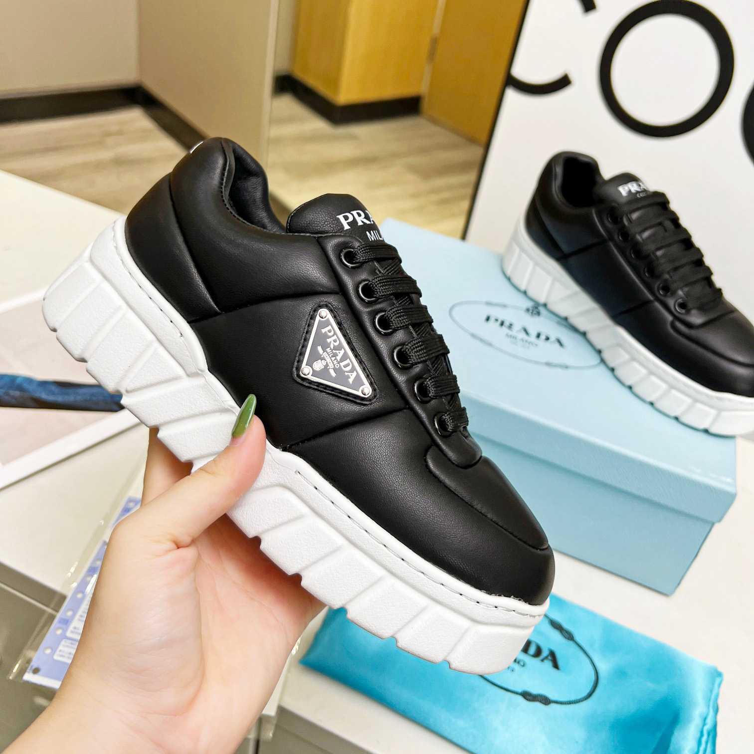 Prada Padded Nappa Leather Sneakers - FashionPlug