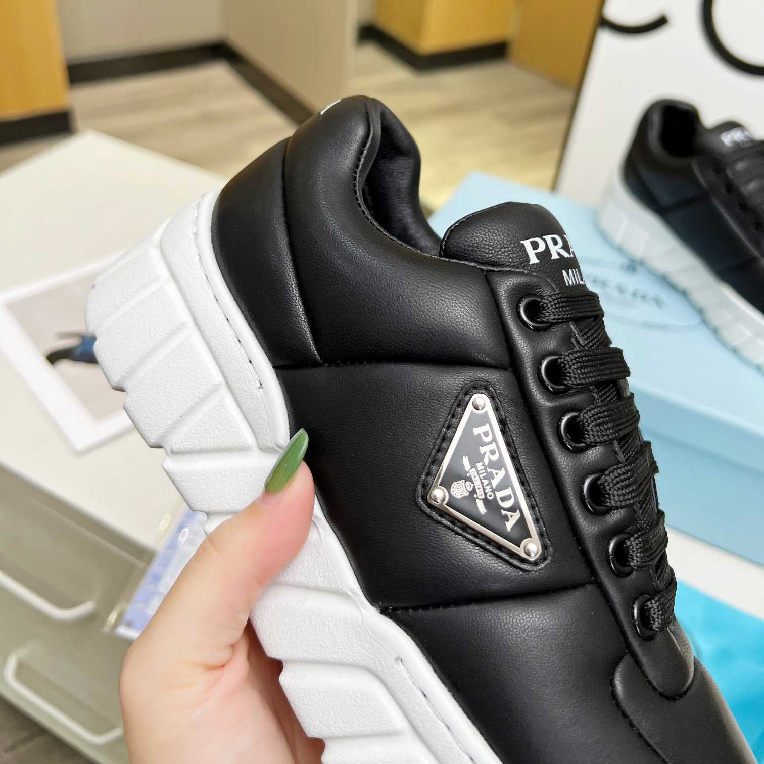 Prada Padded Nappa Leather Sneakers - FashionPlug