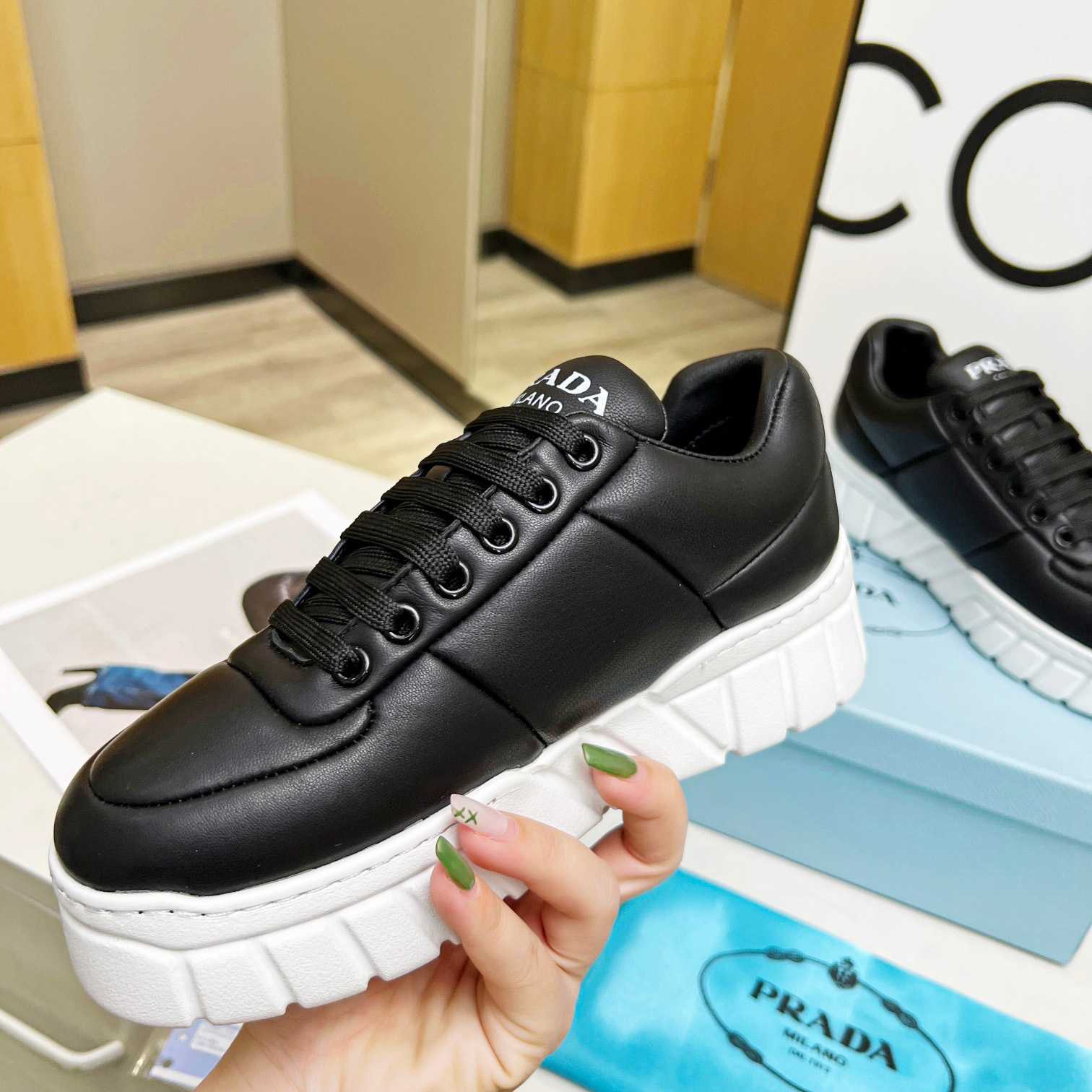 Prada Padded Nappa Leather Sneakers - FashionPlug