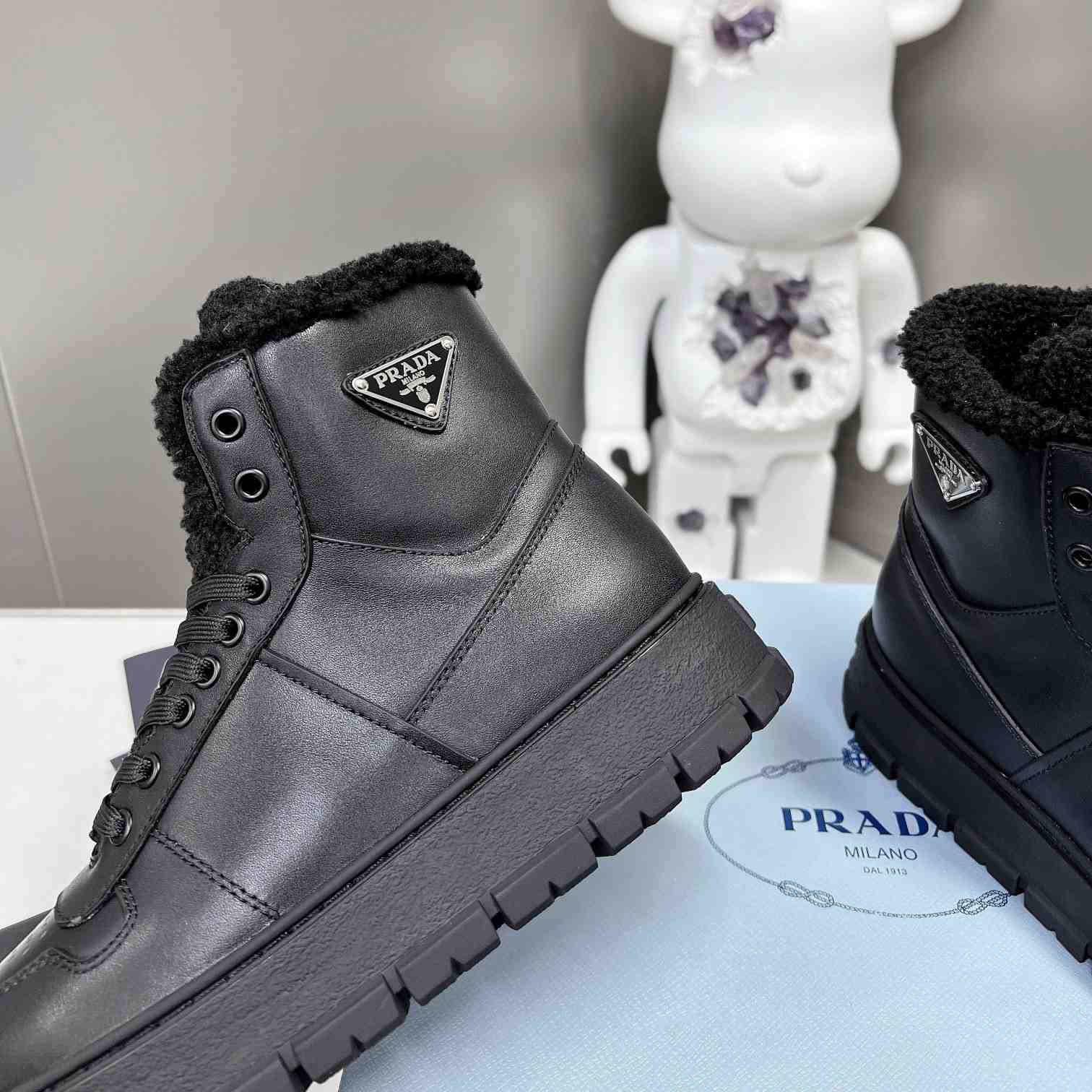 Prada Leather And Shearling High-top Sneakers - FashionPlug