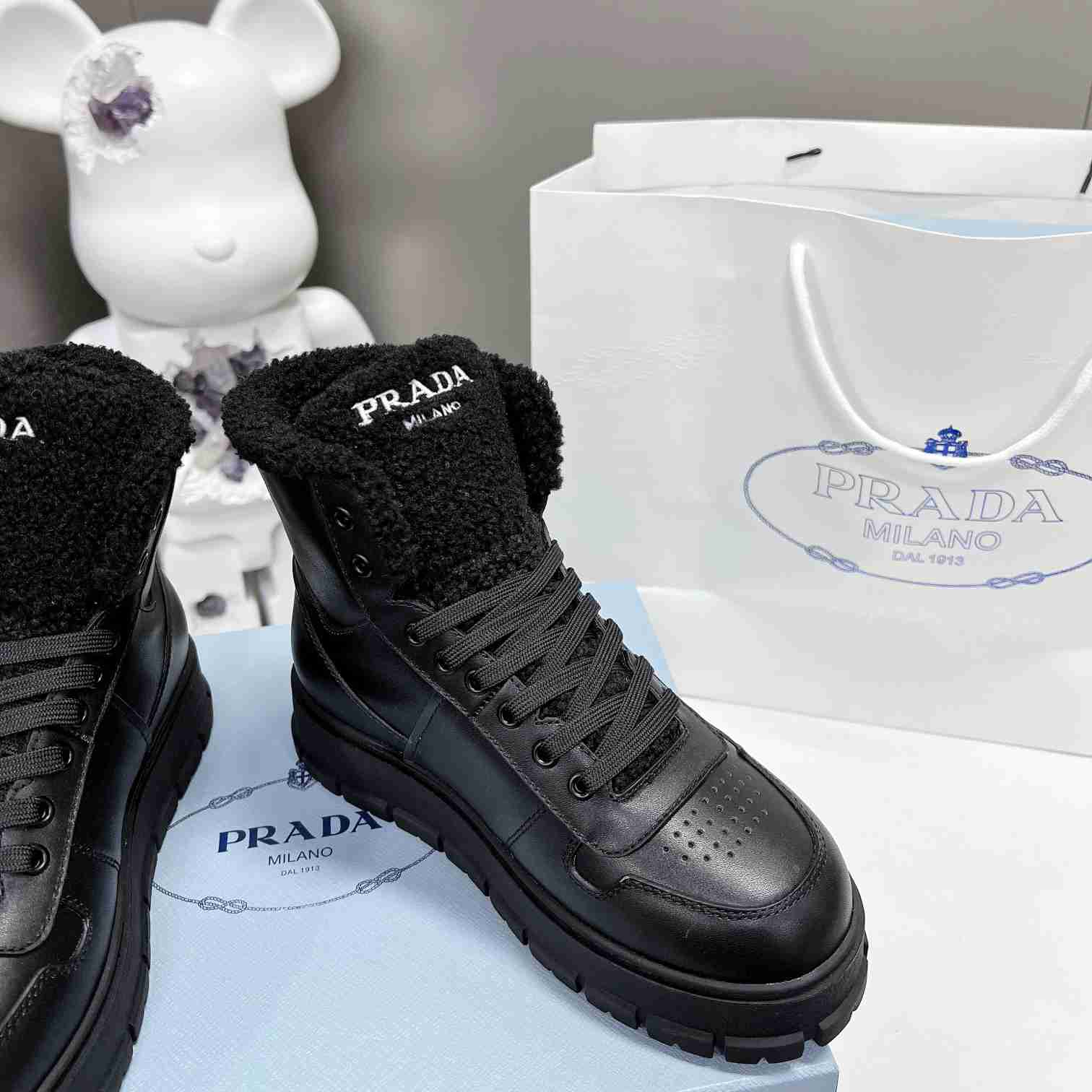 Prada Leather And Shearling High-top Sneakers - FashionPlug