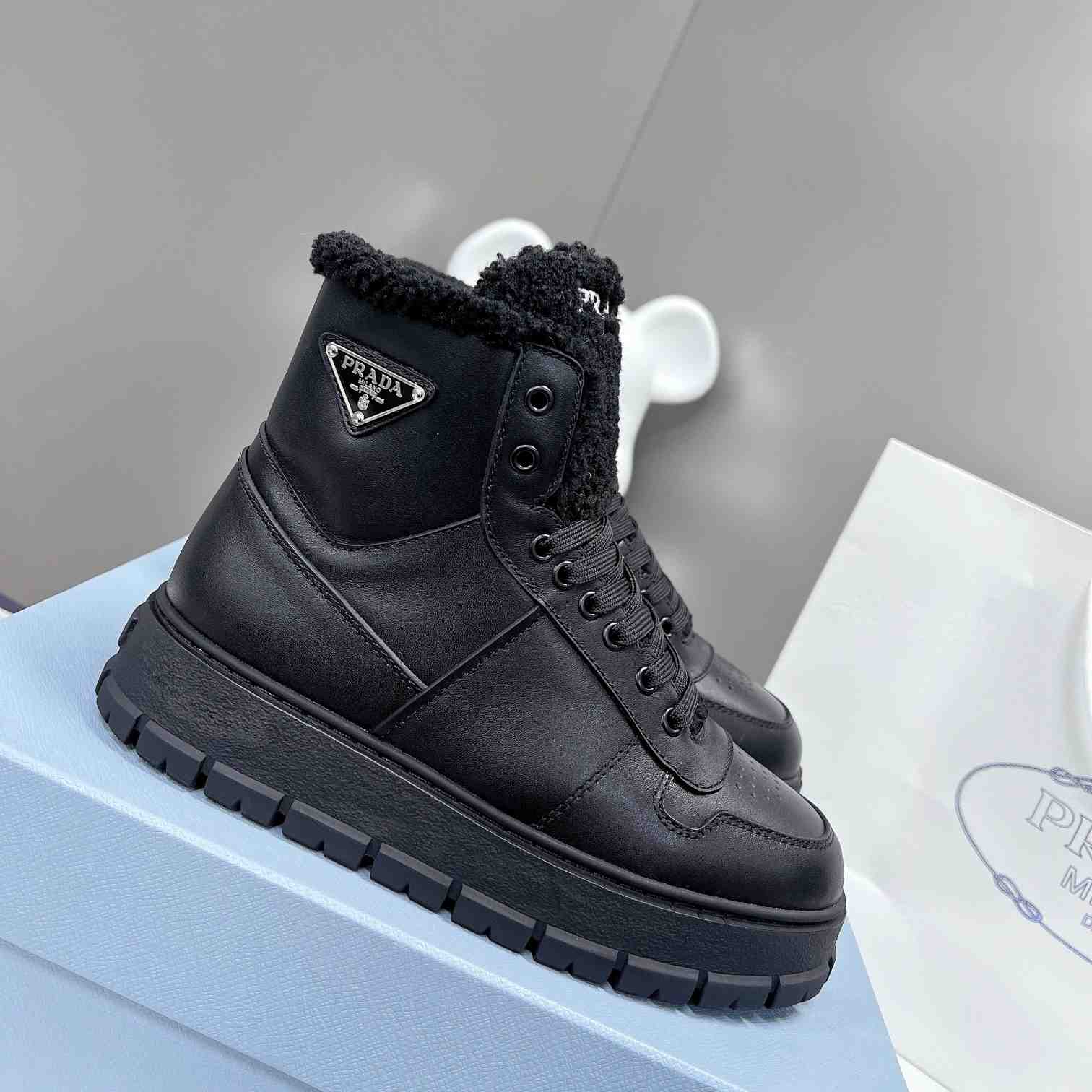 Prada Leather And Shearling High-top Sneakers - FashionPlug