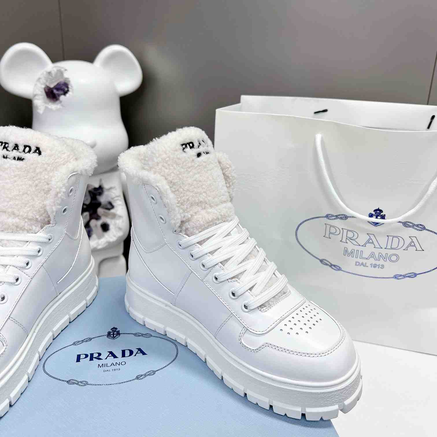 Prada Leather And Shearling High-top Sneakers - FashionPlug
