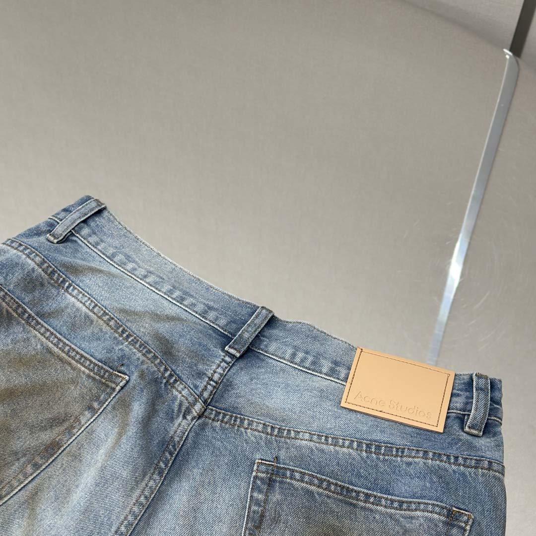 Acne Studios Mud-dyed torn jeans - FashionPlug
