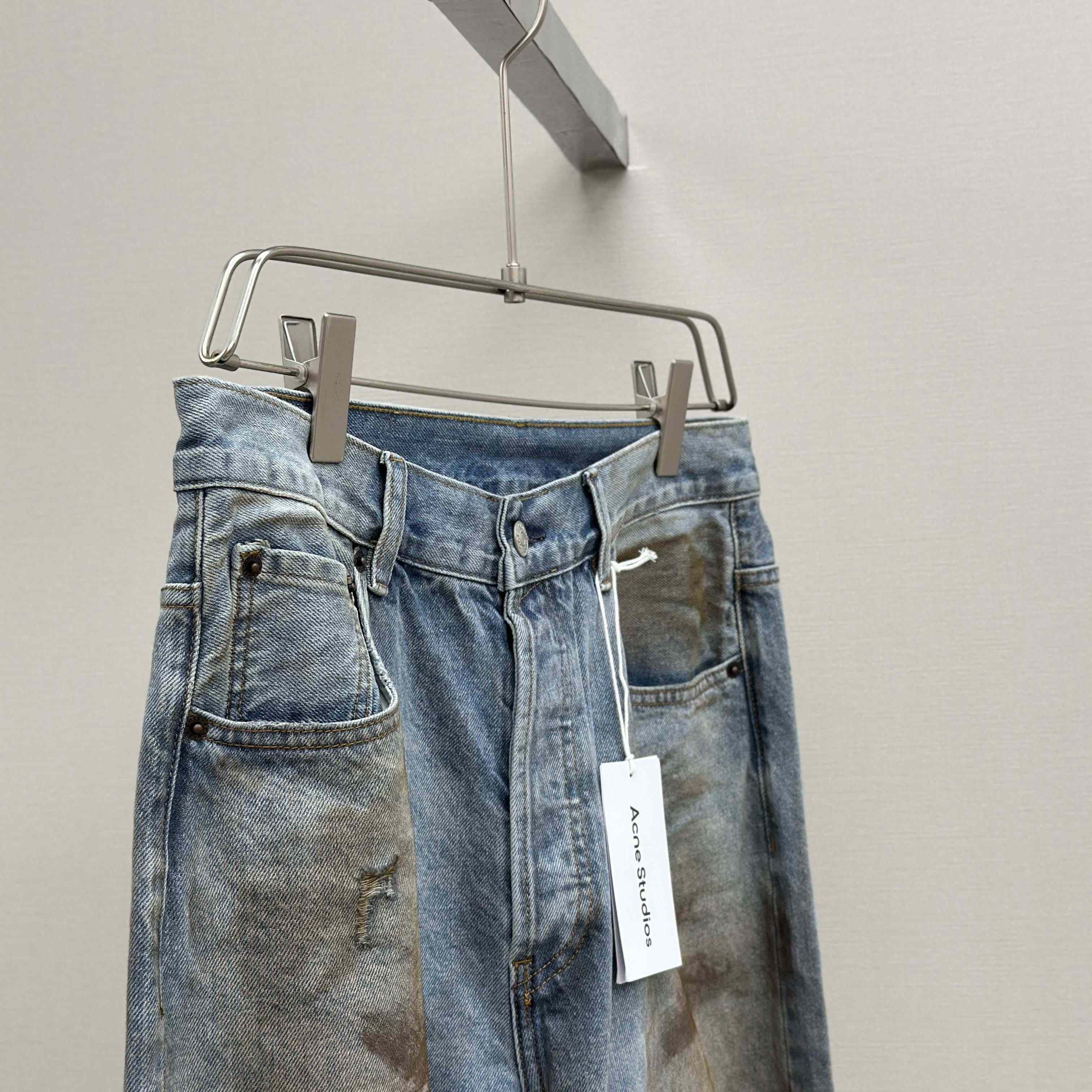 Acne Studios Mud-dyed torn jeans - FashionPlug