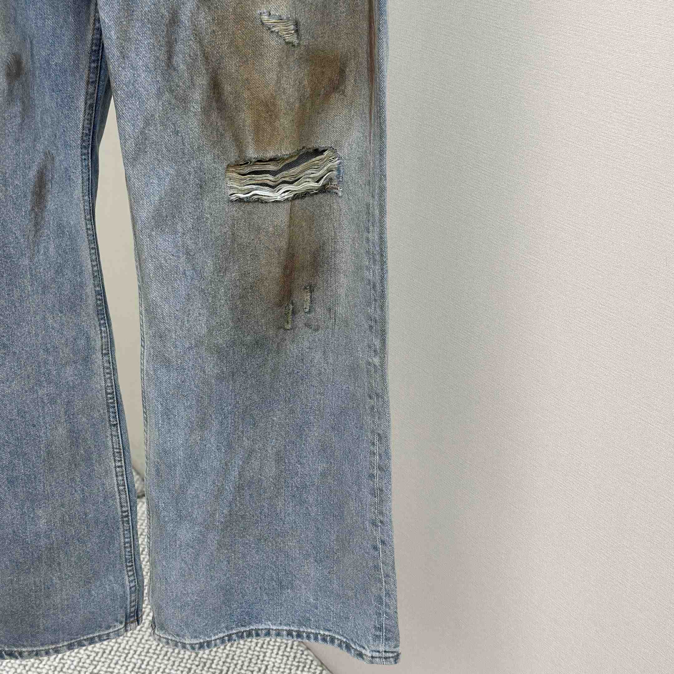 Acne Studios Mud-dyed torn jeans - FashionPlug