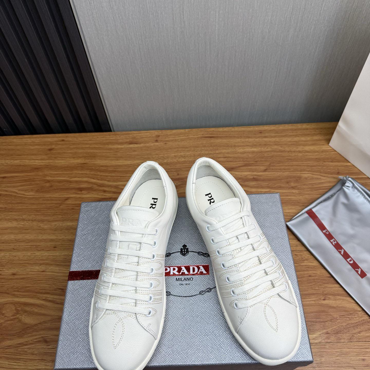 Prada Distressed Leather Sneakers - FashionPlug