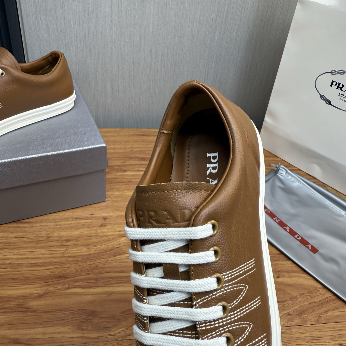 Prada Decorative-Stitching Leather Low-Top Sneakers - FashionPlug