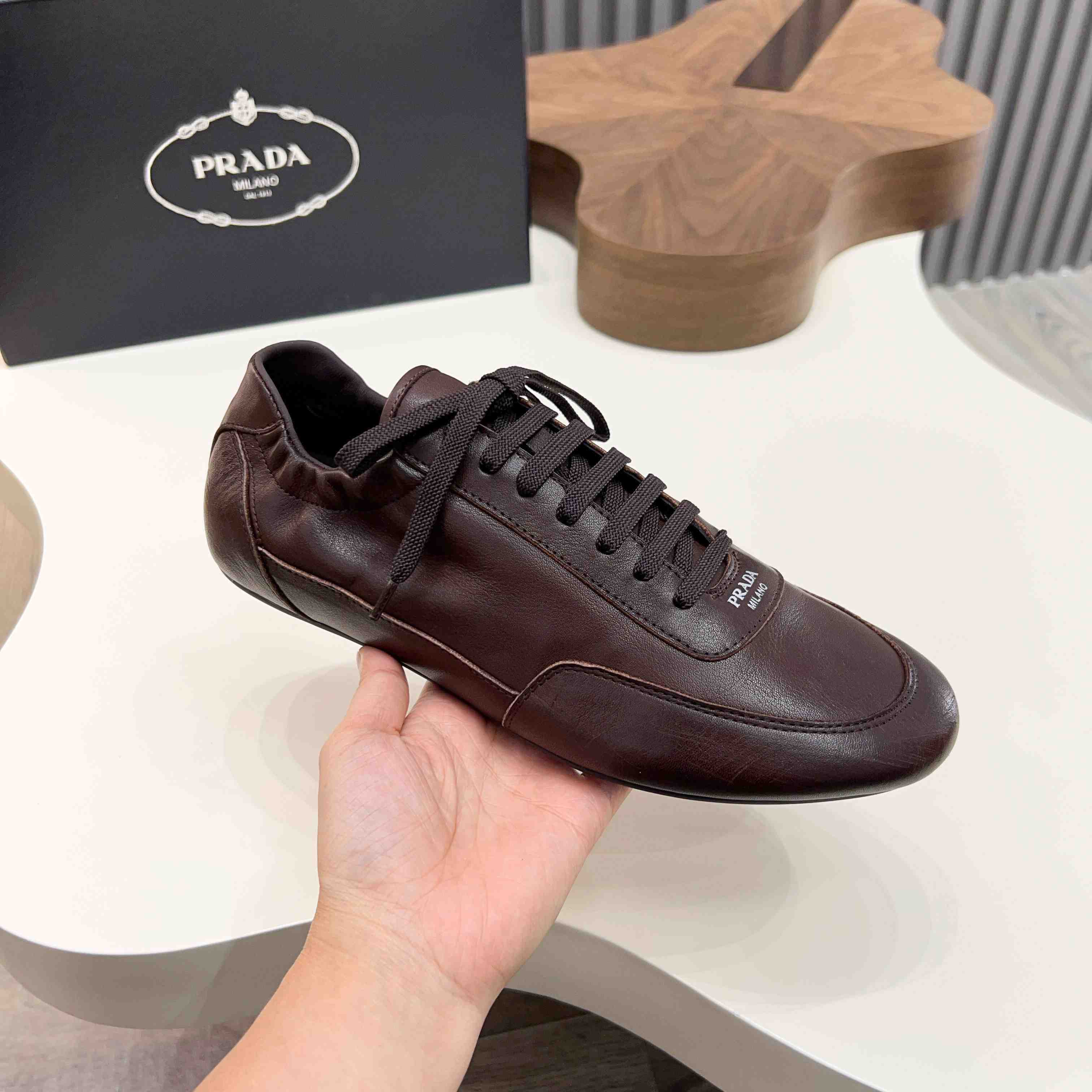 Prada Collapse Leather Sneakers - FashionPlug