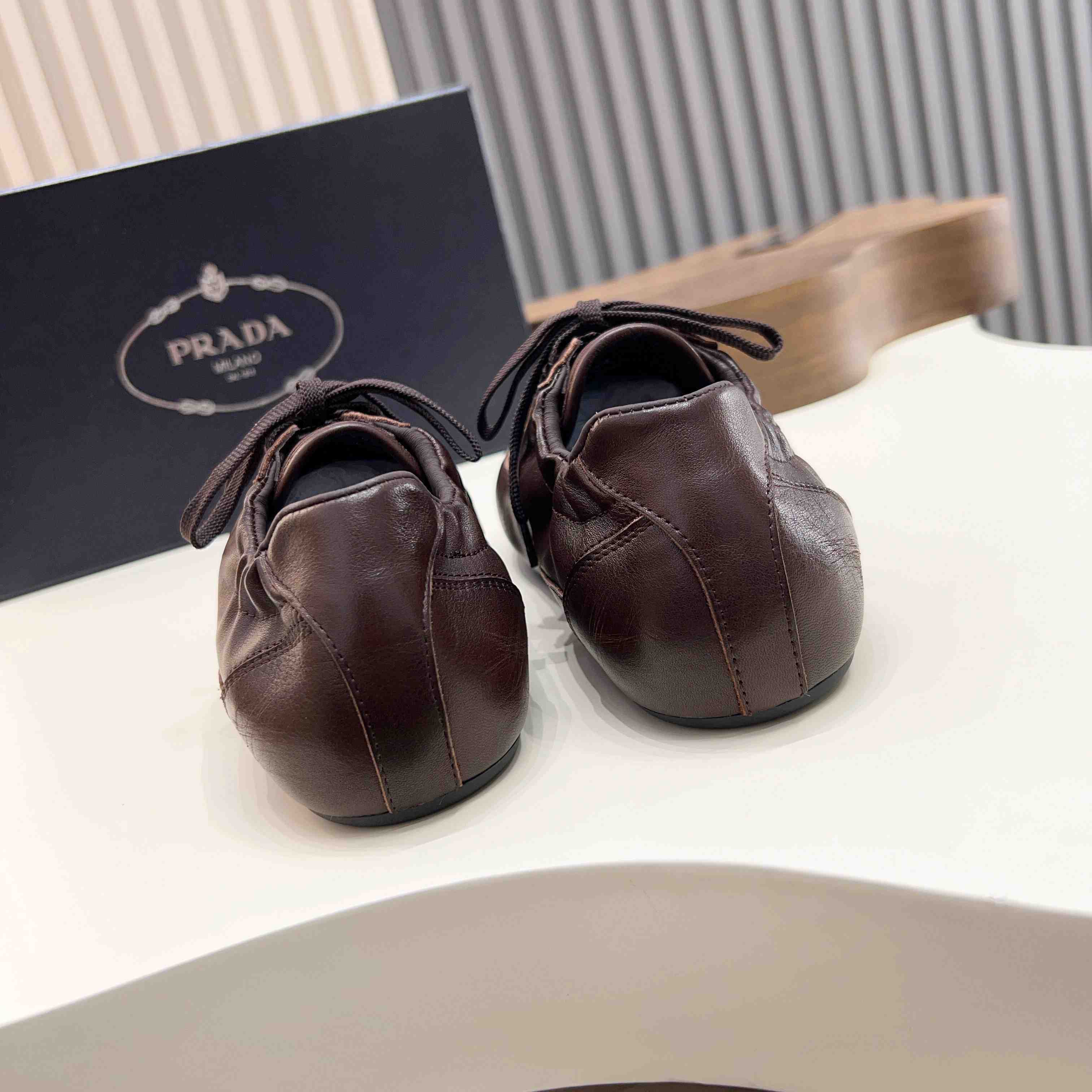 Prada Collapse Leather Sneakers - FashionPlug