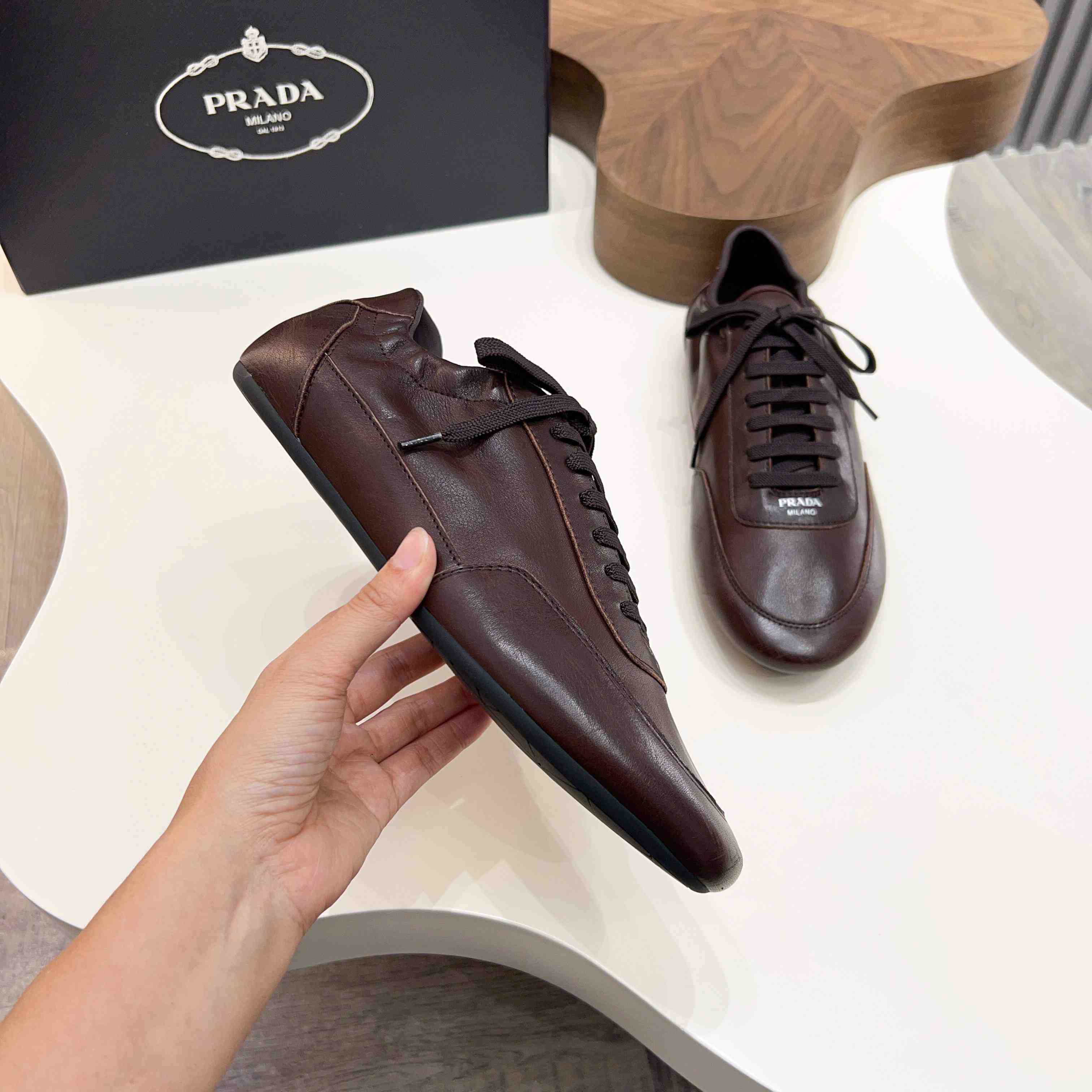 Prada Collapse Leather Sneakers - FashionPlug