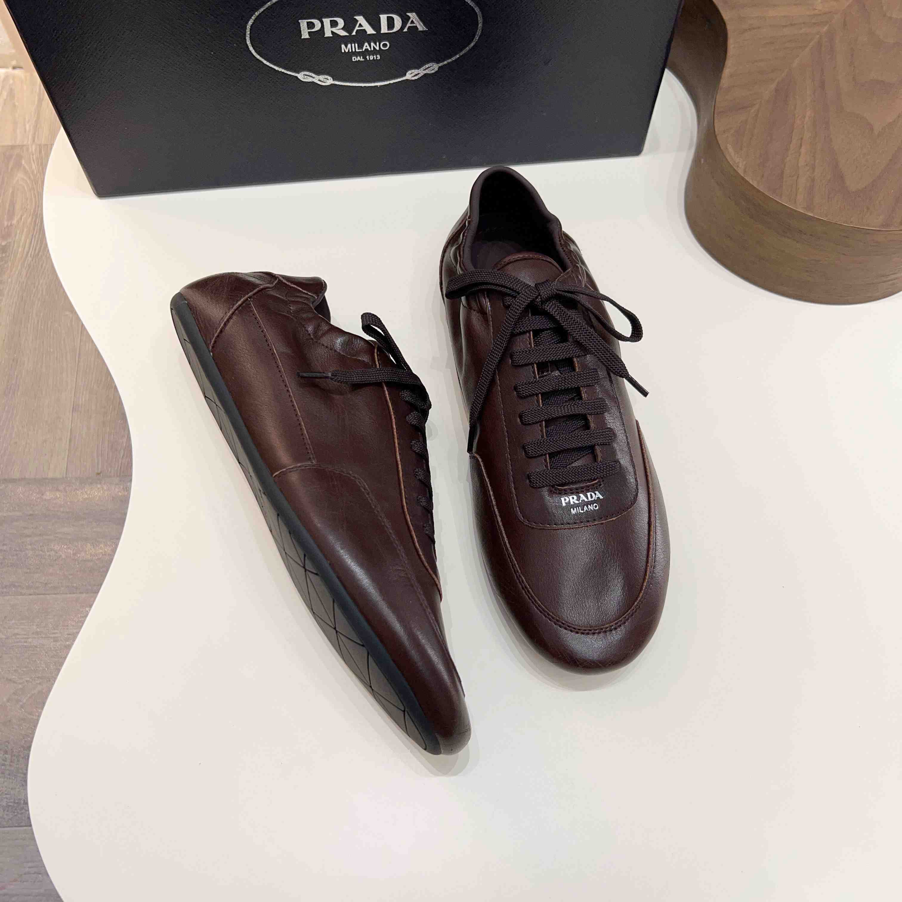 Prada Collapse Leather Sneakers - FashionPlug