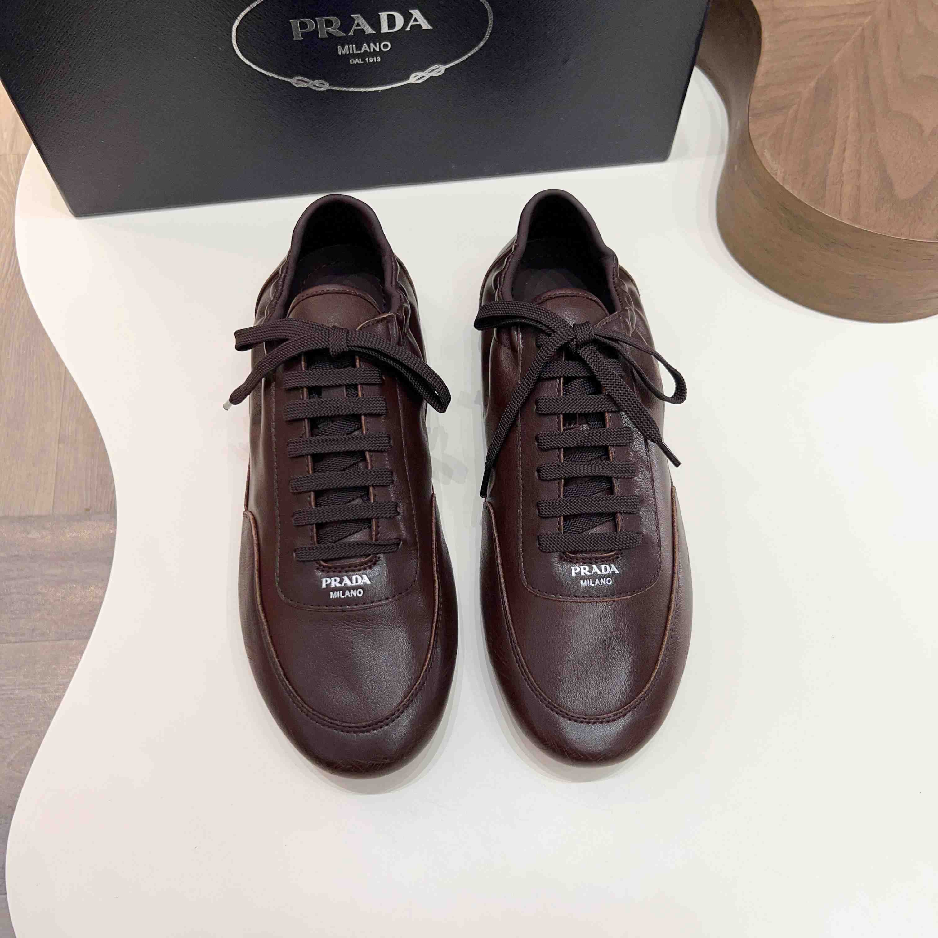Prada Collapse Leather Sneakers - FashionPlug