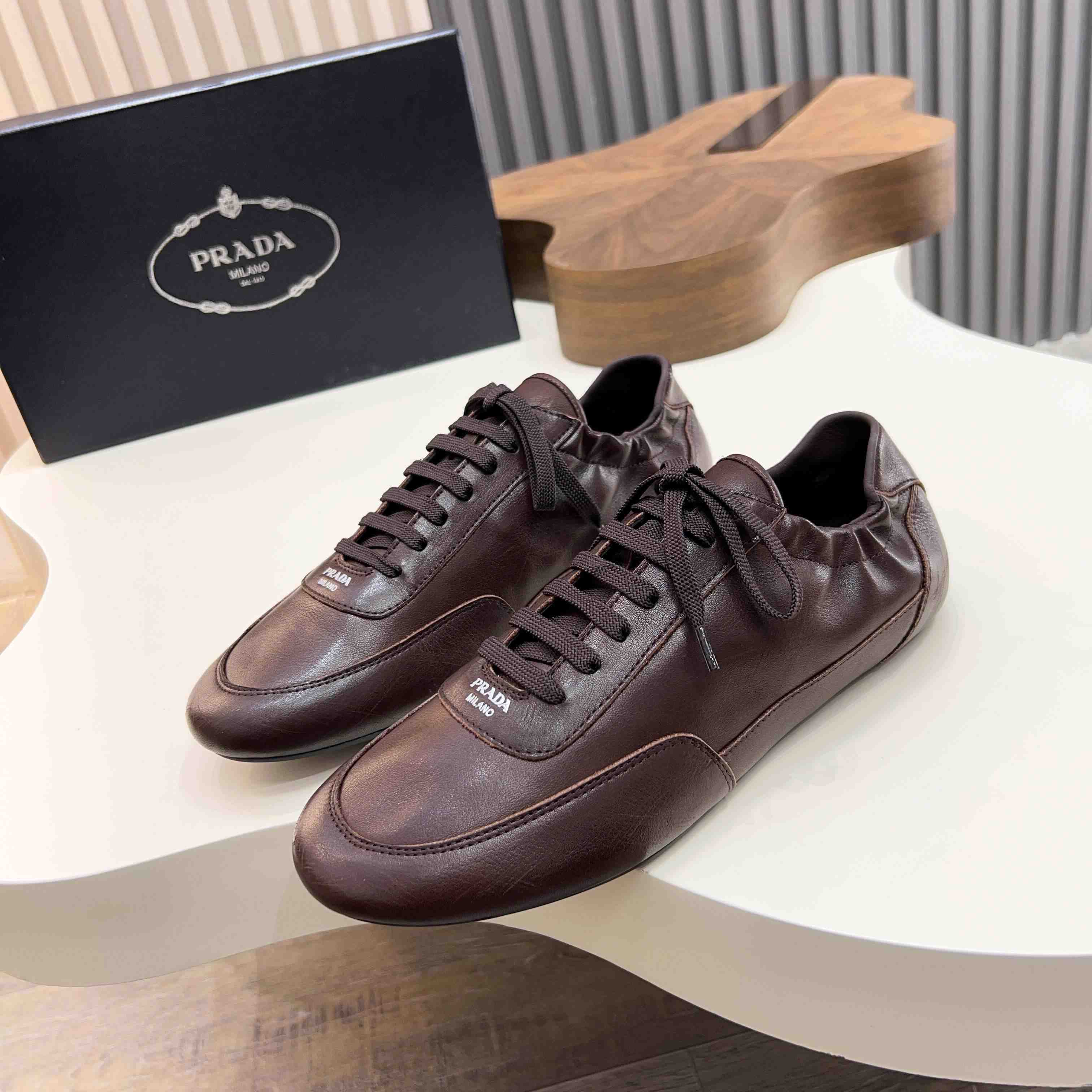 Prada Collapse Leather Sneakers - FashionPlug