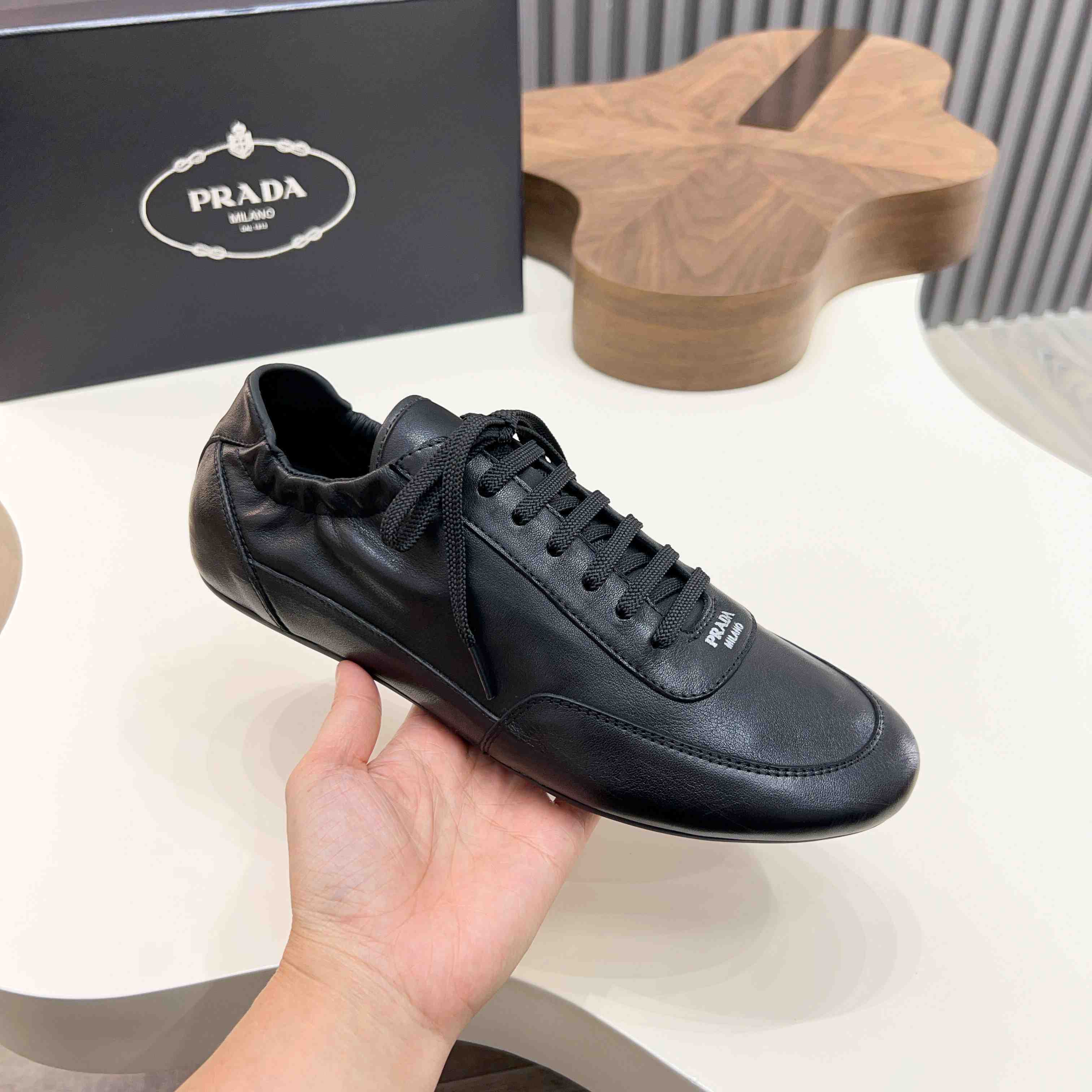 Prada Collapse Leather Sneakers - FashionPlug