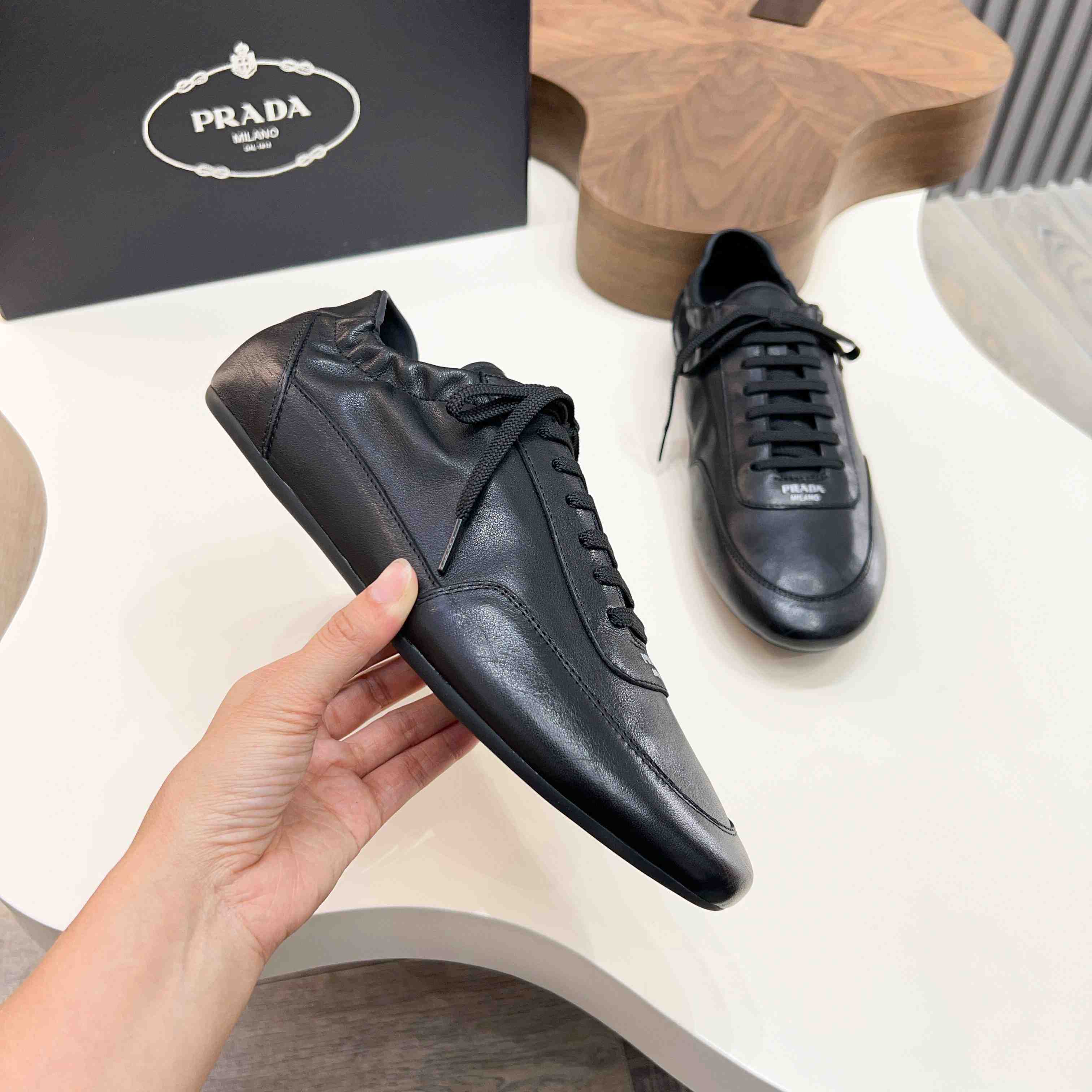 Prada Collapse Leather Sneakers - FashionPlug