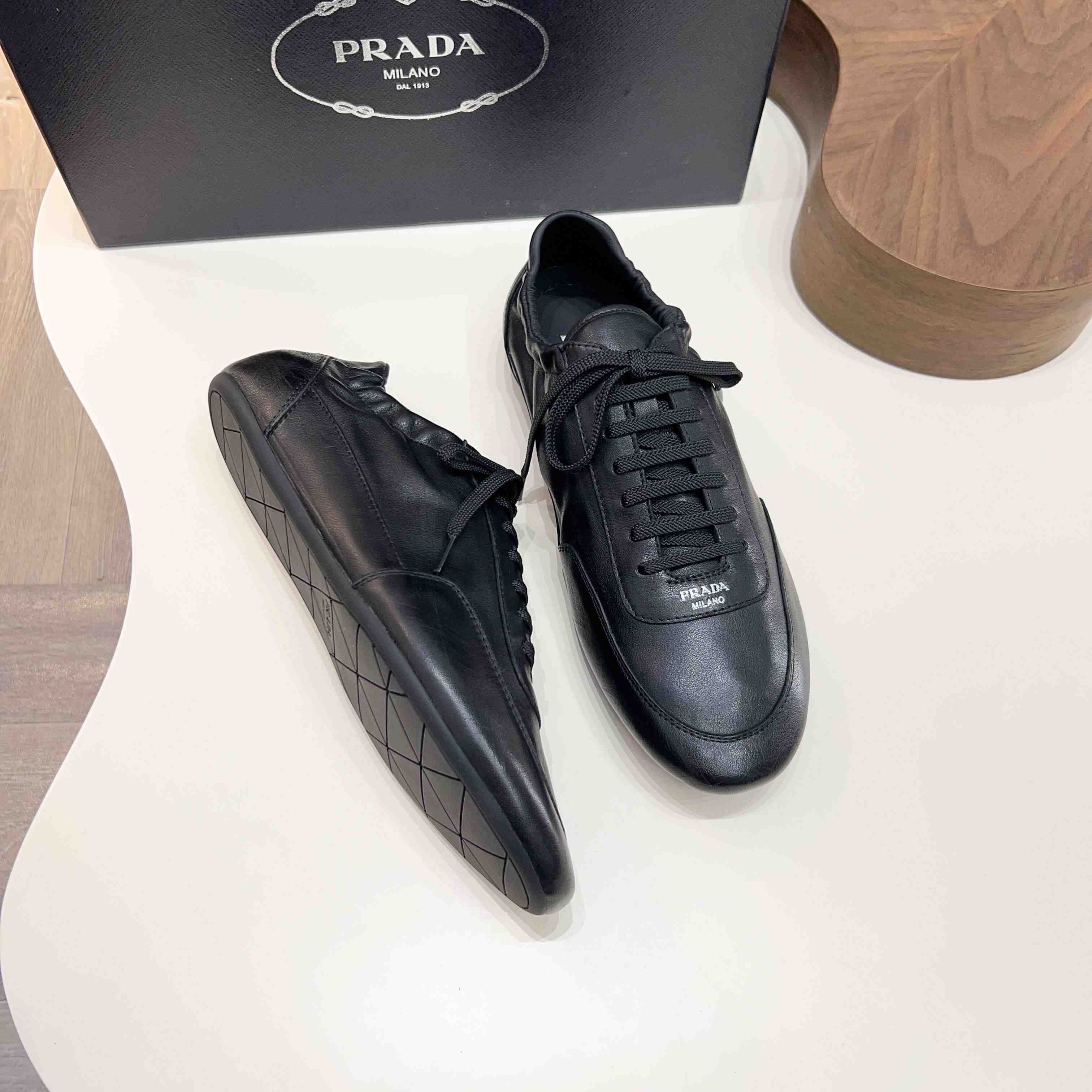 Prada Collapse Leather Sneakers - FashionPlug