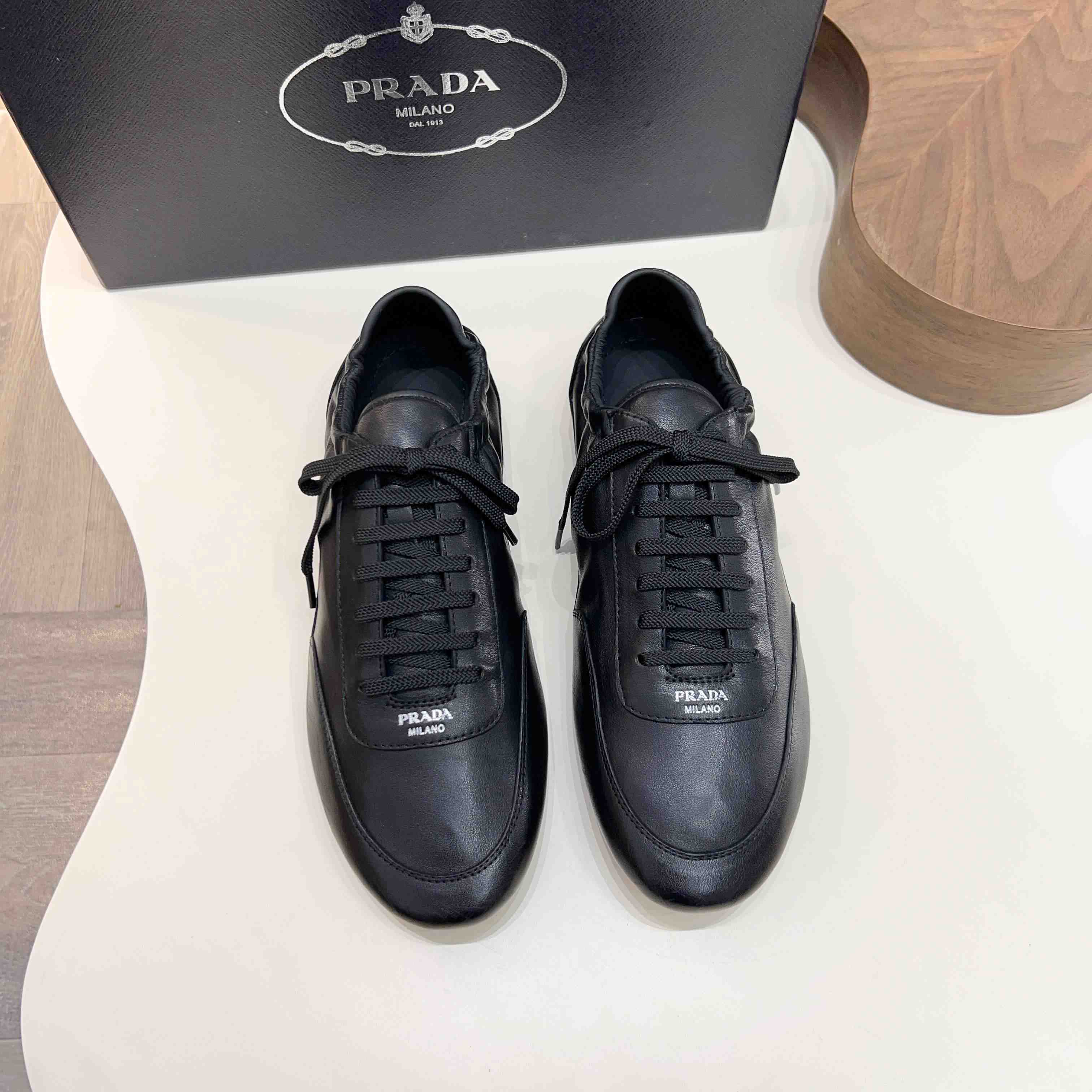 Prada Collapse Leather Sneakers - FashionPlug