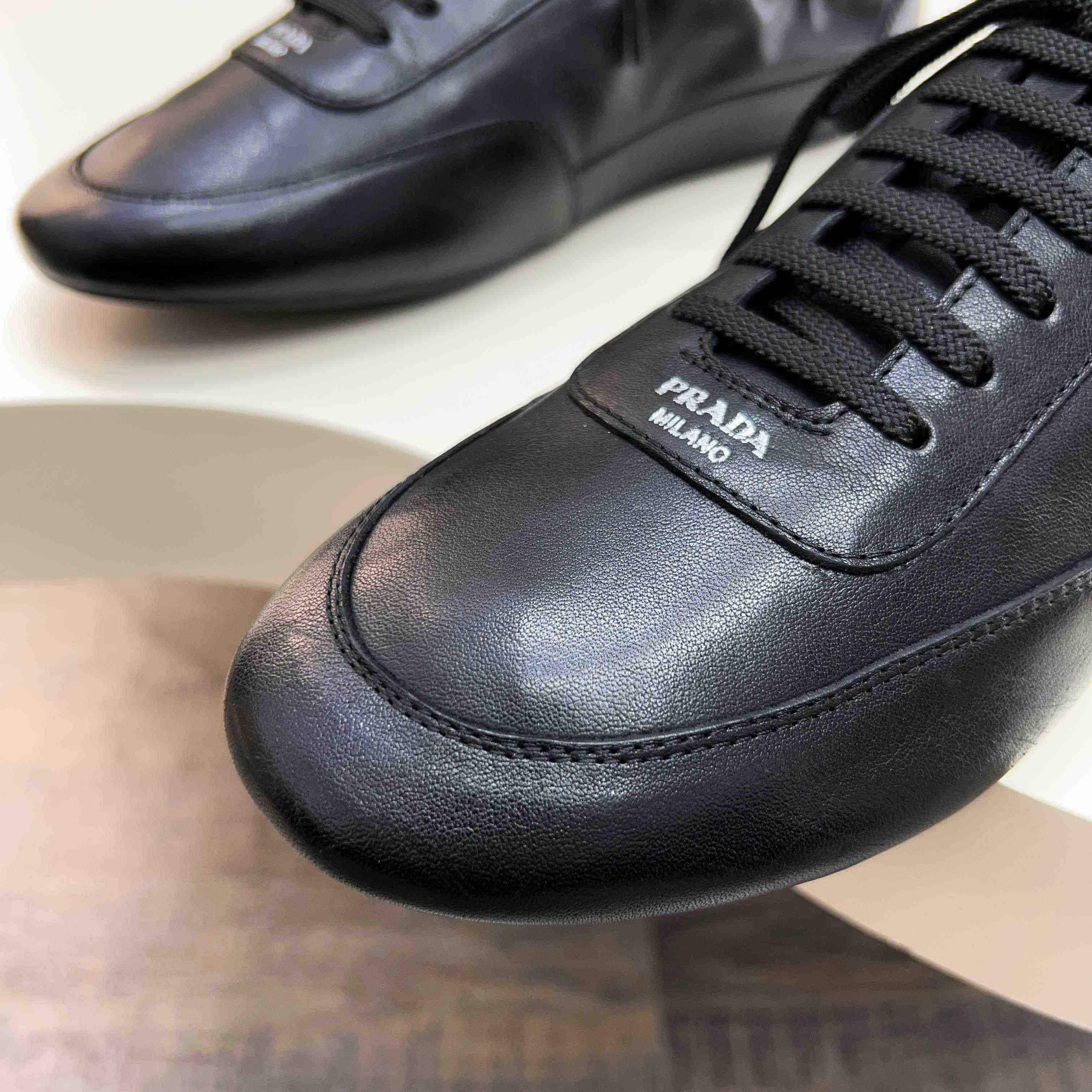 Prada Collapse Leather Sneakers - FashionPlug